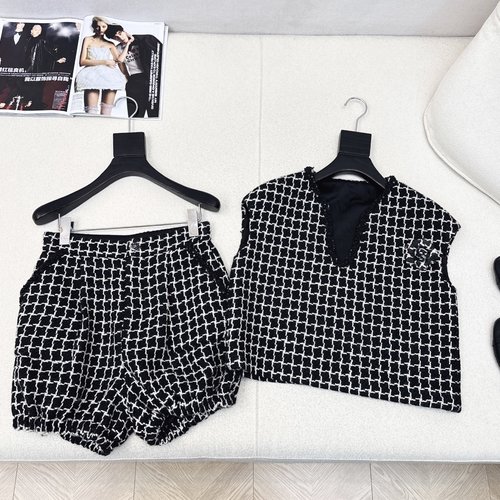 Chanel Exclusive Black and White Knitted Suit with Camellia Brooch